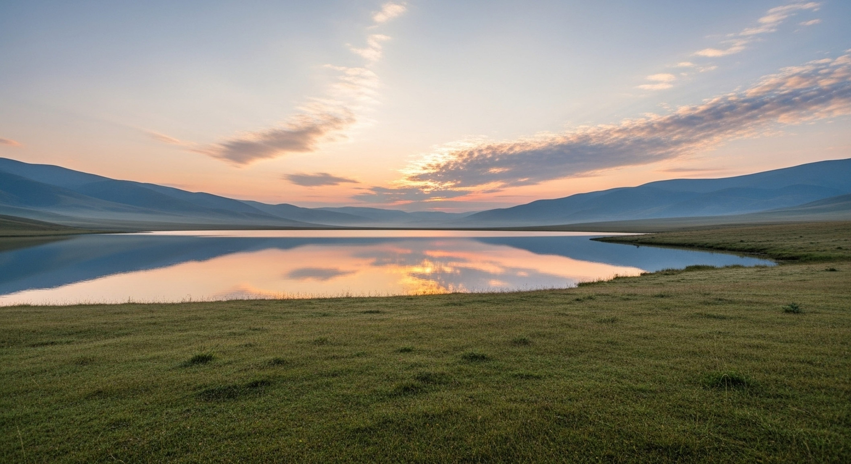 Grassland and lake at sunset