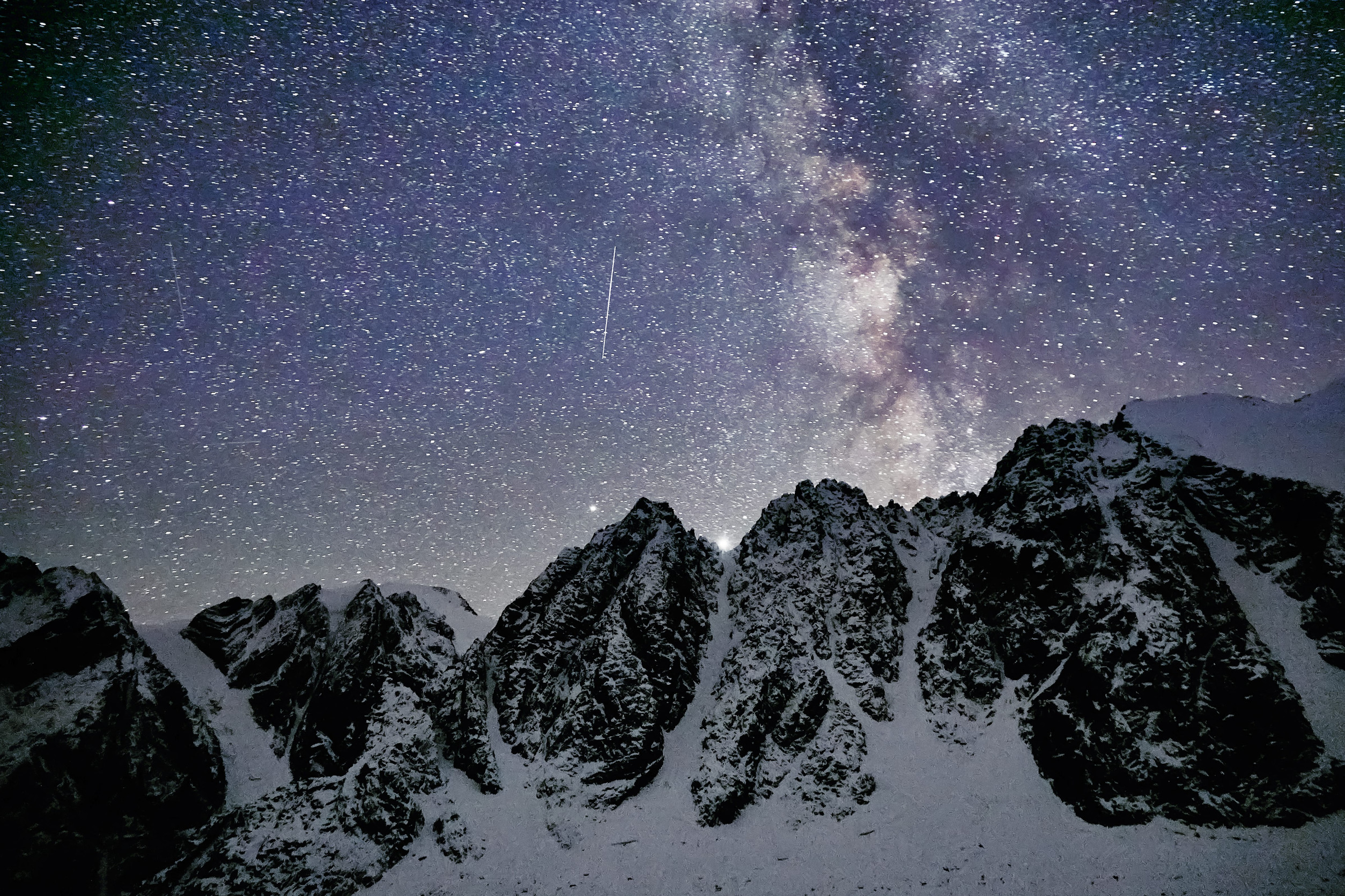 Milky Way and snowy mountains in Altai at night