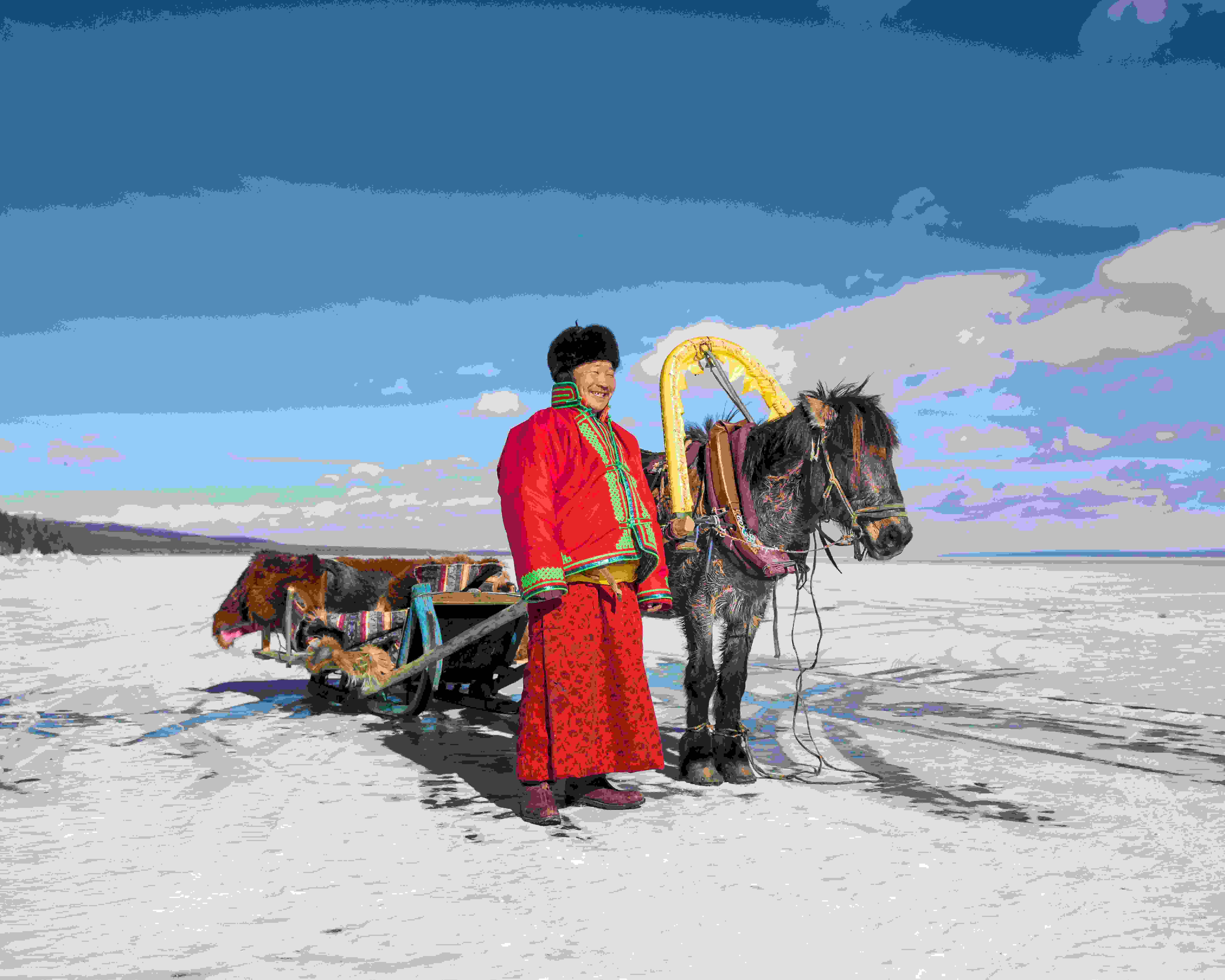 Mongolian man with a horse sledge